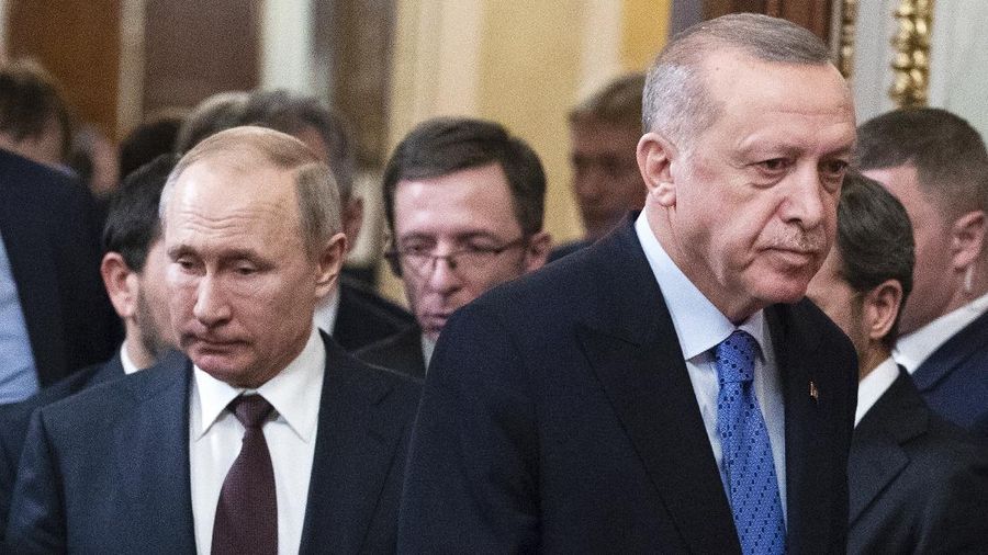 Russian President Vladimir Putin, left, and Turkish President Recep Tayyip Erdogan arrive for a news conference after their talks in the Kremlin, in Moscow, Russia, Thursday, March 5, 2020. Russian President Vladimir Putin and his Turkish counterpart, Recep Tayyip Erdogan, say they have reached agreements that could end fighting in northwestern Syria. (AP Photo/Pavel Golovkin, Pool)