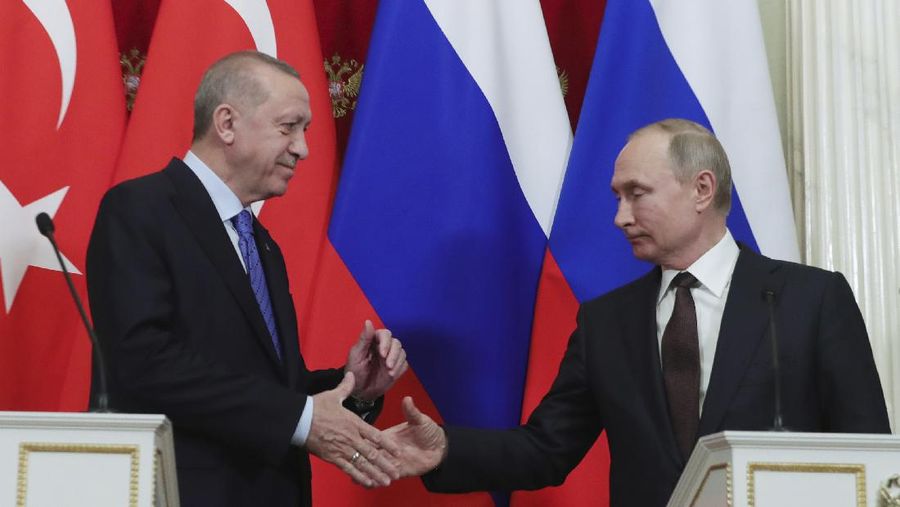 Russia's President Vladimir Putin, right, and Turkish President Recep Tayyip Erdogan shake hands after a joint news conference followed six-hour talks in the Kremlin, in Moscow, Russia, Thursday, March 5, 2020. (Presidential Press Service via AP, Pool)