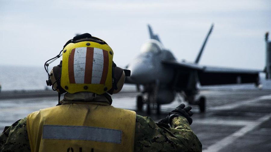 201015-N-KP021-1003 SOUTH CHINA SEA (Oct. 15, 2020) Aviation Boatswain’s Mate (Handling) 1st Class Keyonnia Cook, from Augusta, Georgia, signals to the pilot of an F/A-18E assigned to the “Eagles” of Strike Fighter Squadron (VFA) 115 aboard the aircraft carrier USS Ronald Reagan (CVN 76) while conducting security and stability operations in the South China Sea. Ronald Reagan, the flagship of Carrier Strike Group 5, provides a combat-ready force that protects and defends the U.S. as well as the collective maritime interests of its allies and partners in the Indo-Pacific. (U.S. Navy photo by Mass Communication Specialist 2nd Class Codie L. Soule)