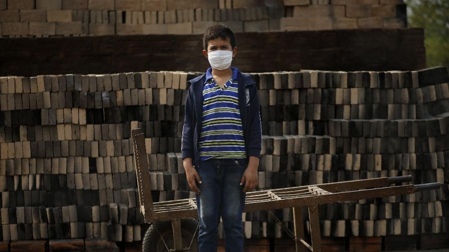 Unused school materials lay on a shelf decorated with an image of Gen. Porfirio Díaz, who was president of Mexico from 1848 to 1876, at a school in the community of Nuevo Yibeljoj, Chiapas state, Mexico, Friday, Sept. 11, 2020. Amid the new coronavirus pandemic, Mexican education officials recently said that enrollment for the new school year was down about 10%, but teachers warn that many students enrolled out of habit, but aren't participating. (AP Photo/Eduardo Verdugo)