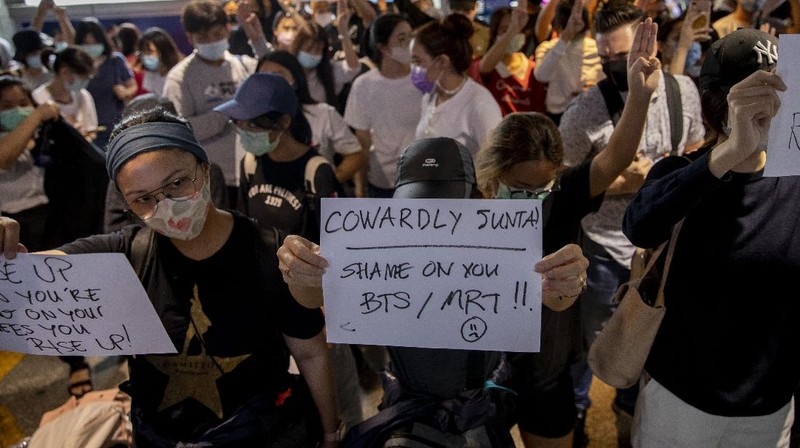 A pro-democracy protester covered in blue paint lies on a road during a protest in Udom Suk, suburbs of Bangkok, Thailand, Saturday, Oct. 17, 2020. The authorities in Bangkok shut down mass transit systems and set up roadblocks Saturday as Thailand’s capital faced a fourth straight day of determined anti-government protests. (AP Photo/Gemunu Amarasinghe)