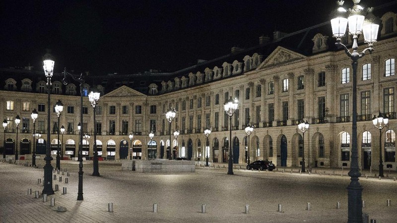People walk in the empty center of Lyon, central France, Saturday, Oct. 17, 2020. France is deploying 12,000 police officers to enforce a new curfew that came into effect Friday night for the next month to slow the virus spread, and will spend another 1 billion euros to help businesses hit by the new restrictions. (AP Photo/Laurent Cipriani)