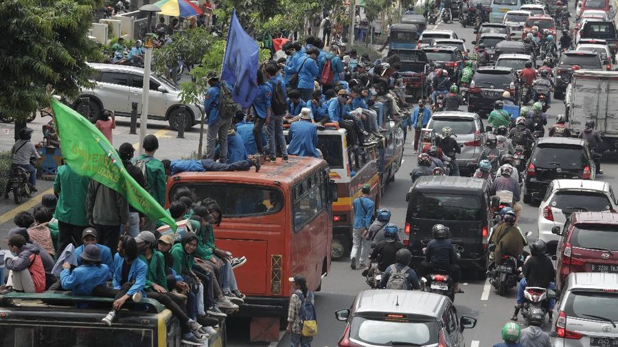 Massa Mahasiswa  konvoi dengan bus di Kawasan Salemba menuju Istana untuk Aksi unjuk rasa menentang UU Cipta Kerja, Selasa (20/10/2020). Ketua Konfederasi Aliansi Serikat Buruh Indonesia (KASBI) Nining Elitos mengatakan demonstrasi digelar berbarengan dengan momen satu tahun Presiden Joko Widodo (Jokowi) dan Wakil Presiden KH Ma'ruf Amin. Merespons aksi massa, Kapolres Jakarta Pusat Kombes Heru Novianto mengatakan, pihaknya telah menerima laporan intelijen terkait rencana aksi massa. Mereka yang berunjuk rasa berasal dari mahasiswa hingga buruh. (վ/ Muhammad Sabki(