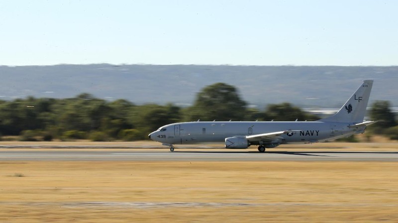 A U.S. Navy P-8 Poseidon takes off from Perth Airport, Australia, en route to rejoin ongoing search operations for the missing Malaysia Airlines Flight 370, Saturday, April 12, 2014. With no new underwater signals detected, Australian Prime Minister Tony Abbott said Saturday that the massive search for the Malaysian jet would likely continue 