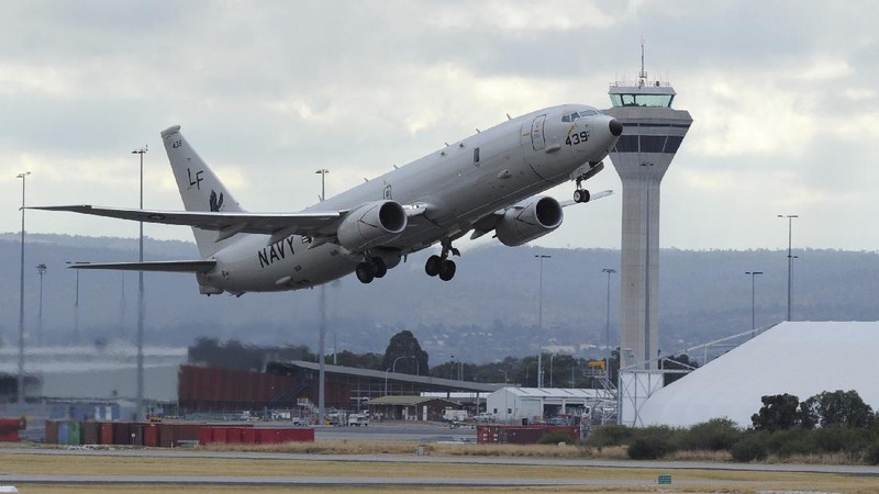 A U.S. Navy P-8 Poseidon takes off from Perth Airport, Australia, en route to rejoin ongoing search operations for the missing Malaysia Airlines Flight 370, Saturday, April 12, 2014. With no new underwater signals detected, Australian Prime Minister Tony Abbott said Saturday that the massive search for the Malaysian jet would likely continue 
