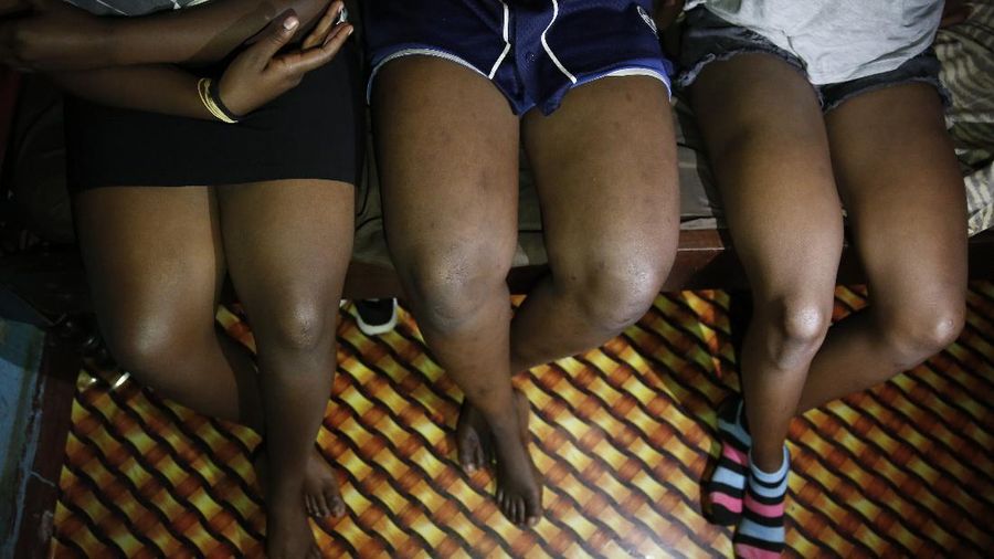 Teenage girls who became sex workers after schools in Kenya were closed in March due to coronavirus restrictions, sit in the rented room where they work in Nairobi, Kenya Thursday, Oct. 1, 2020. The girls saw their mothers' sources of income vanish when Kenya's government restricted movement to prevent the spread of the virus, and now engage in the sex work to help with household bills. (AP Photo/Brian Inganga)