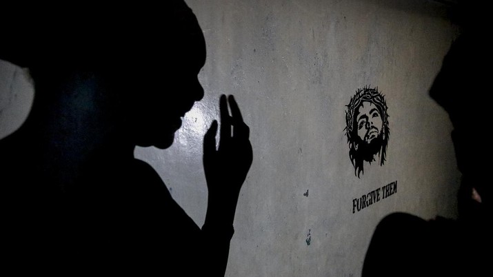 A teenage girl who became a sex worker after schools in Kenya were closed in March due to coronavirus restrictions, casts a shadow on the wall of the rented room where she and others work in Nairobi, Kenya Thursday, Oct. 1, 2020. The girls saw their mothers' sources of income vanish when Kenya's government restricted movement to prevent the spread of the virus, and now engage in the sex work to help with household bills. (AP Photo/Brian Inganga)