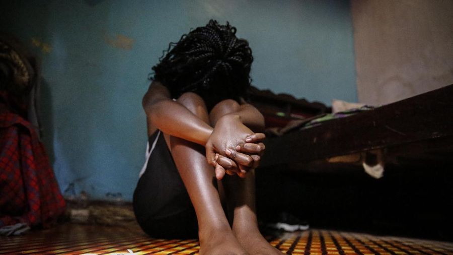 A teenage girl who became a sex worker after schools in Kenya were closed in March due to coronavirus restrictions, sits in the rented room where she and others work, in Nairobi, Kenya Thursday, Oct. 1, 2020. The girls saw their mothers' sources of income vanish when Kenya's government restricted movement to prevent the spread of the virus, and now engage in the sex work to help with household bills. (AP Photo/Brian Inganga)