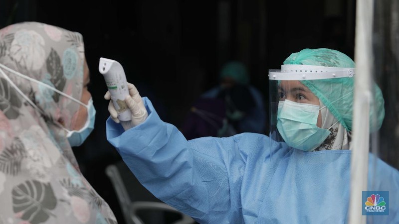 Dokter memperagakan proses vaksinasi saat simulasi pemberian vaksin di Puskesmas Depok, Jawa Barat, Kamis (22/10). Pemerintah Kota Depok akan menggelar simulasi pemberian vaksin corona. Pemberian vaksin idealnya sebanyak 60 persen dari jumlah penduduk Kota Depok. Adapun yang hadir bukanlah warga sungguhan yang hendak divaksin. Hanya perwakilan dari Pemkot Depok saja. Terdapat sejumlah tahapan alur yang akan diterapkan Pemerintah Kota Depok dalam pemberian vaksin. Orang yang masuk dalam kriteria mendapat vaksin akan diundang untuk datang ke puskesmas. Nantinya mereka duduk di ruang tunggu dengan penerapan protokol kesehatan. Mereka kemudian menunggu giliran dipanggil petugas. Setelah itu masuk ke ruangan untuk disuntik vaksin. Orang yang telah divaksin akan diregistrasi petugas guna memantau perkembangannya secara berkala.  (CNBC Indonesia/ Muhammad Sabki)