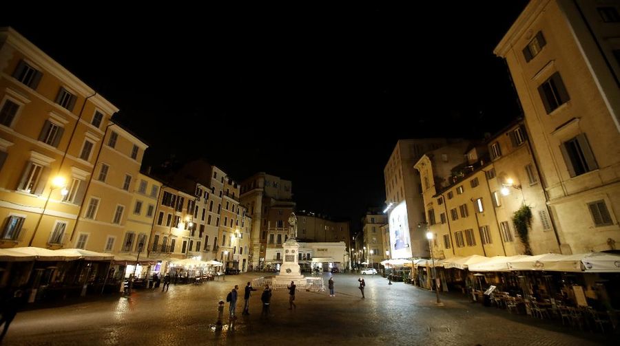 A view of an empty Piazza Navona Square after the start of a curfew, Saturday, Oct. 24, 2020. Italian Premier Giuseppe Conte, who imposed severe-stay-at-home limits on citizens early on, then gradually eased travel and other restrictions, has been leaving it up to regional governors in this current surge of infections to order restrictions such as overnight curfews, including in places like Rome, Milan and Naples. (AP Photo/Alessandra Tarantino)