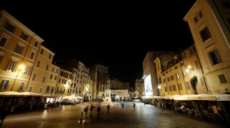 A view of an empty Piazza Navona Square after the start of a curfew, Saturday, Oct. 24, 2020. Italian Premier Giuseppe Conte, who imposed severe-stay-at-home limits on citizens early on, then gradually eased travel and other restrictions, has been leaving it up to regional governors in this current surge of infections to order restrictions such as overnight curfews, including in places like Rome, Milan and Naples. (AP Photo/Alessandra Tarantino)