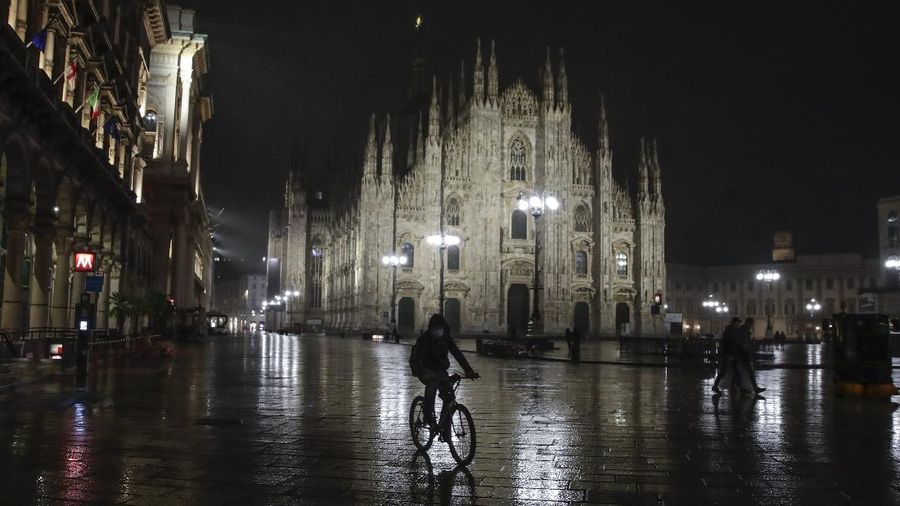 A view of an empty Piazza Navona Square after the start of a curfew, Saturday, Oct. 24, 2020. Italian Premier Giuseppe Conte, who imposed severe-stay-at-home limits on citizens early on, then gradually eased travel and other restrictions, has been leaving it up to regional governors in this current surge of infections to order restrictions such as overnight curfews, including in places like Rome, Milan and Naples. (AP Photo/Alessandra Tarantino)