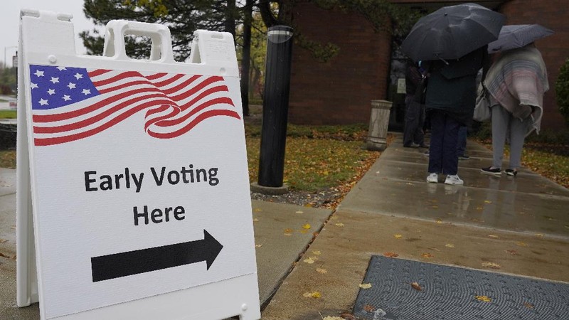 People wait in line during early voting at Elk Grove Village Hall in Elk Grove Village, Ill., Friday, Oct. 23, 2020. (AP Photo/Nam Y. Huh)