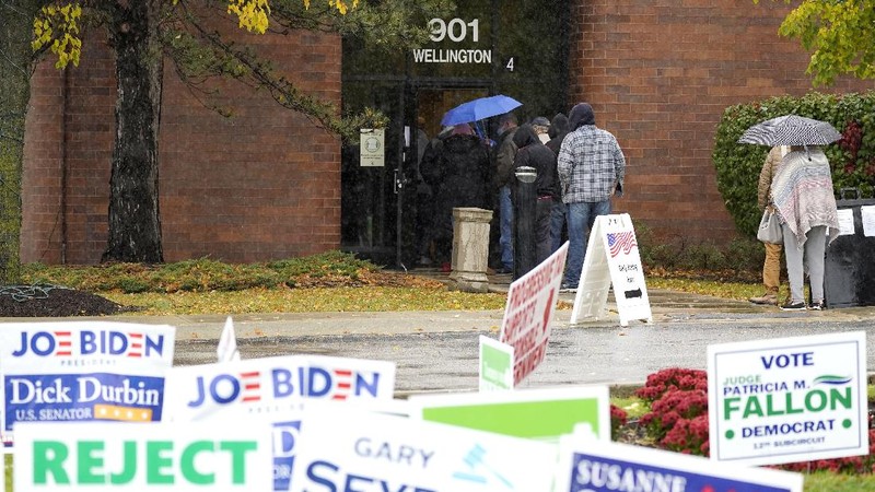 People wait in line during early voting at Elk Grove Village Hall in Elk Grove Village, Ill., Friday, Oct. 23, 2020. (AP Photo/Nam Y. Huh)