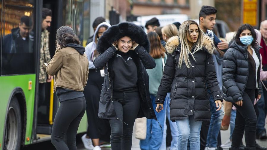Workers walk over London Bridge towards the City of London financial district during the morning rush hour, in London, Monday, Jan. 24, 2022. The British government have asked people to return to working in offices starting Monday as they ease coronavirus restrictions. (AP Photo/Matt Dunham)