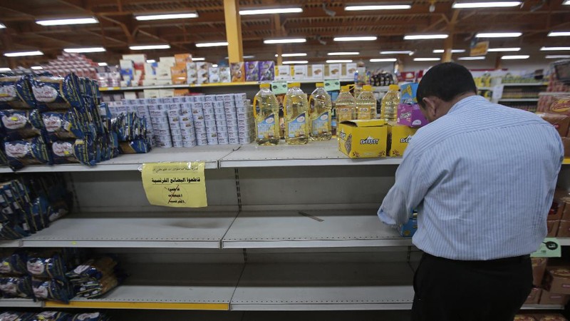 A worker removes French products from a supermarket, in Sanaa, Yemen, Monday, Oct. 26, 2020. Muslims in the Middle East and beyond on Monday called for boycotts of French products and for protests over caricatures of the Prophet Muhammad they deem insulting and blasphemous, but France's president has vowed his country will not back down from its secular ideals and defense of free speech. (AP Photo/Hani Mohammed)
