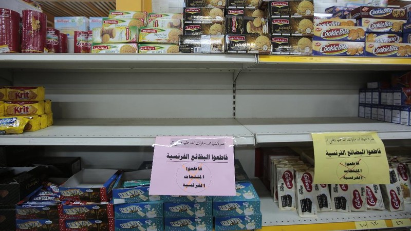 A worker removes French products from a supermarket, in Sanaa, Yemen, Monday, Oct. 26, 2020. Muslims in the Middle East and beyond on Monday called for boycotts of French products and for protests over caricatures of the Prophet Muhammad they deem insulting and blasphemous, but France's president has vowed his country will not back down from its secular ideals and defense of free speech. (AP Photo/Hani Mohammed)