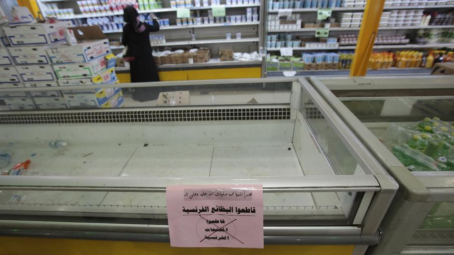 A worker removes French products from a supermarket, in Sanaa, Yemen, Monday, Oct. 26, 2020. Muslims in the Middle East and beyond on Monday called for boycotts of French products and for protests over caricatures of the Prophet Muhammad they deem insulting and blasphemous, but France's president has vowed his country will not back down from its secular ideals and defense of free speech. (AP Photo/Hani Mohammed)
