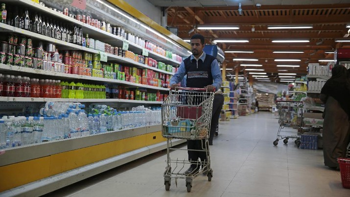 A worker removes French products from a supermarket, in Sanaa, Yemen, Monday, Oct. 26, 2020. Muslims in the Middle East and beyond on Monday called for boycotts of French products and for protests over caricatures of the Prophet Muhammad they deem insulting and blasphemous, but France's president has vowed his country will not back down from its secular ideals and defense of free speech. (AP Photo/Hani Mohammed)