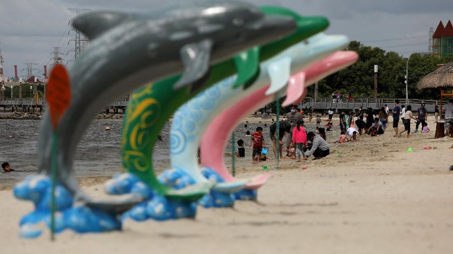 Wisatawan menikmati suasana Pantai Lagoon, Ancol, Jakarta, Jumat (30/10/2020). Libur Nasional dan Cuti bersama dimanfaatkan warga Jakarta untuk bertamasya ke tempat wisata di Jakarta. (CNBC Indonesia/Andrean Kristianto)