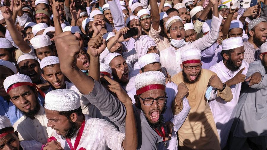Supporters of Islamist parties shout slogans during a protest after Friday prayers in Dhaka, Bangladesh, Friday, Oct. 30, 2020. Thousands of Muslims and activists marched through streets and rallied across Bangladesh’s capital on Friday against the French president’s support of secular laws that deem caricatures of the Prophet Muhammad as protected under freedom of speech. (AP Photo/Mahmud Hossain Opu)