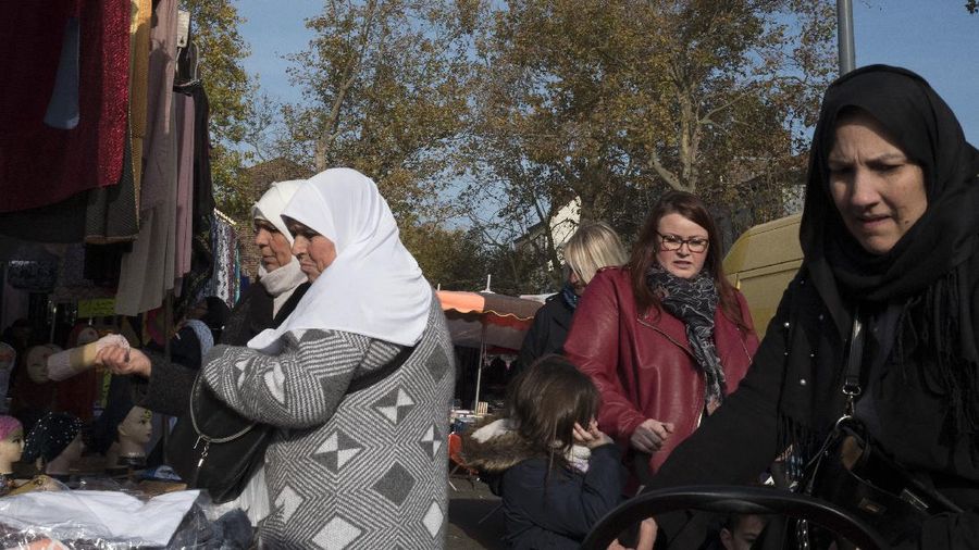 Veiled Muslim women shop at an open air market in Lille, northern France, Thursday, Oct. 31, 2019. Islam is the No. 2 religion in a largely Catholic nation where many, especially the anti-immigration far-right, hone to France's roots and view its Muslim population, which grew from the nation's colonial past, as intruders and a threat to the French way of life, including secularism. (AP Photo/Michel Spingler)