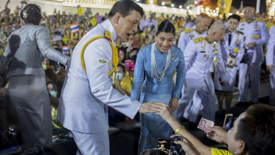 King Maha Vajiralongkorn and Queen Suthida greet supporters in Bangkok, Thailand, Sunday, Nov. 1, 2020. Under increasing pressure from protesters demanding reforms to the monarchy, Thailand's king and queen met Sunday with thousands of adoring supporters in Bangkok, mixing with citizens in the street after attending a religious ceremony inside the Grand Palace. (AP Photo/Wason Wanichakorn)