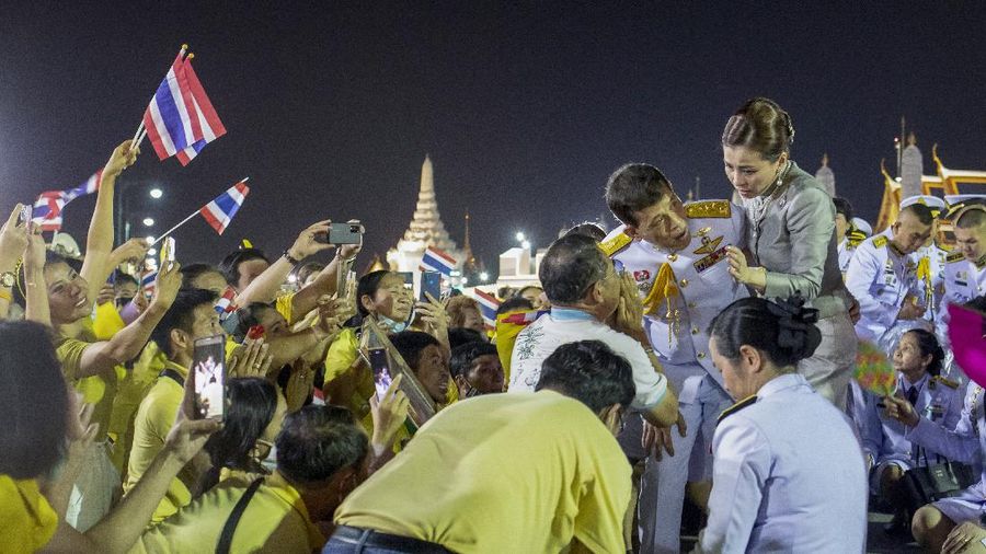 King Maha Vajiralongkorn and Queen Suthida greet supporters in Bangkok, Thailand, Sunday, Nov. 1, 2020. Under increasing pressure from protesters demanding reforms to the monarchy, Thailand's king and queen met Sunday with thousands of adoring supporters in Bangkok, mixing with citizens in the street after attending a religious ceremony inside the Grand Palace. (AP Photo/Wason Wanichakorn)