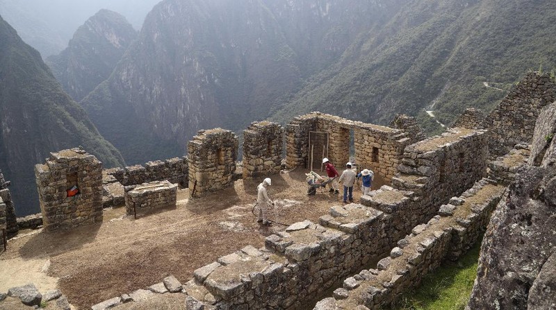 Tourists visit the world-renowned Incan citadel of Machu Picchu as it reopens for the first time since its 8-months-long closure to help curb the spread of COVID-19, in the department of Cusco, Peru, Sunday, Nov. 1, 2020. (AP Photo/Martin Mejia)
