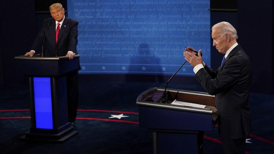 Democratic presidential candidate former Vice President Joe Biden answers a question as President Donald Trump listens during the second and final presidential debate Thursday, Oct. 22, 2020, at Belmont University in Nashville, Tenn. (AP Photo/Morry Gash, Pool)