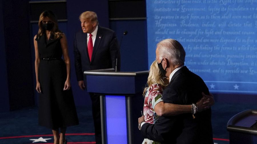 Democratic presidential candidate former Vice President Joe Biden hugs his wife Jill Biden as President Donald Trump stands first lady Melania Trump after the second and final presidential debate Thursday, Oct. 22, 2020, at Belmont University in Nashville, Tenn. (AP Photo/Morry Gash, Pool)