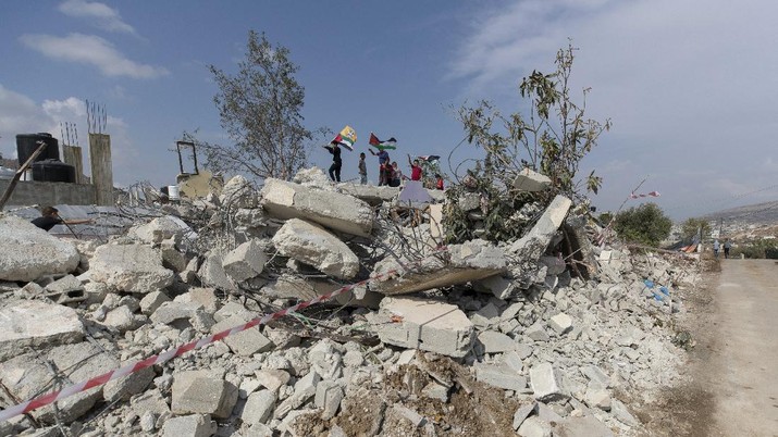 Israel Palestinians Palestinian children play on top of the demolished house of Khalil Dweikat, in the West Bank village of Rojeeb, east of Nablus, Monday, Nov. 2, 2020. The Israeli military said Monday its troops demolished the home of Dweikat, a Palestinian accused of killing an Israeli in a stabbing attack earlier this year. (AP Photo/Nasser Nasser)