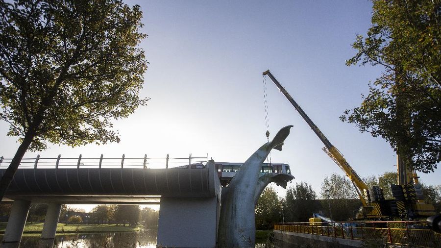 The whale's tail of a sculpture caught the front carriage of a metro train as it rammed through the end of an elevated section of rails with the driver escaping injuries in Spijkenisse, near Rotterdam, Netherlands, Monday, Nov. 2, 2020. (AP Photo/Peter Dejong)
