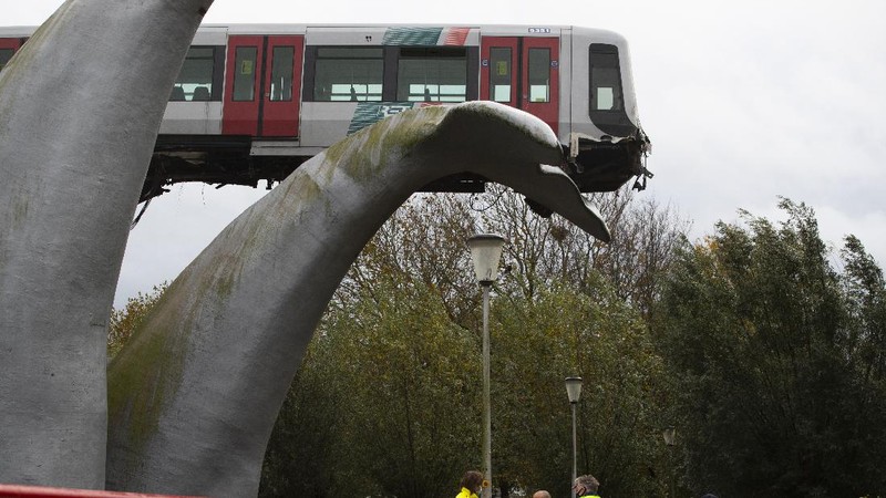 The whale's tail of a sculpture caught the front carriage of a metro train as it rammed through the end of an elevated section of rails with the driver escaping injuries in Spijkenisse, near Rotterdam, Netherlands, Monday, Nov. 2, 2020. (AP Photo/Peter Dejong)