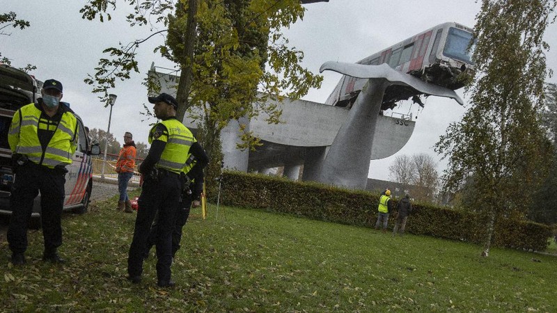 The whale's tail of a sculpture caught the front carriage of a metro train as it rammed through the end of an elevated section of rails with the driver escaping injuries in Spijkenisse, near Rotterdam, Netherlands, Monday, Nov. 2, 2020. (AP Photo/Peter Dejong)