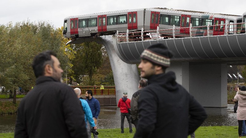 The whale's tail of a sculpture caught the front carriage of a metro train as it rammed through the end of an elevated section of rails with the driver escaping injuries in Spijkenisse, near Rotterdam, Netherlands, Monday, Nov. 2, 2020. (AP Photo/Peter Dejong)