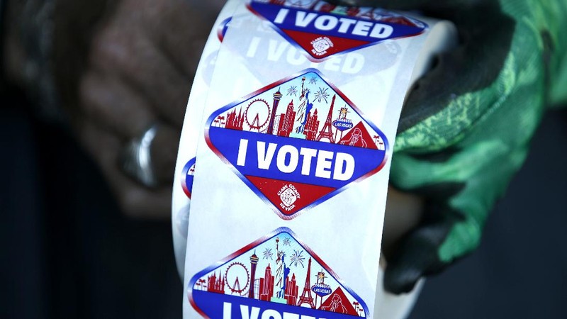 FILE - In this Saturday, Oct. 17, 2020, file photo a poll worker displays 