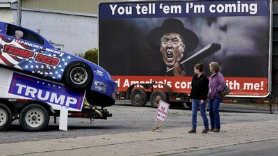 Supporters of President Donald Trump walk to a campaign rally at the Williamsport Regional Airport in Montoursville, Pa, Saturday, Oct. 31, 2020. (AP Photo/Gene J. Puskar)