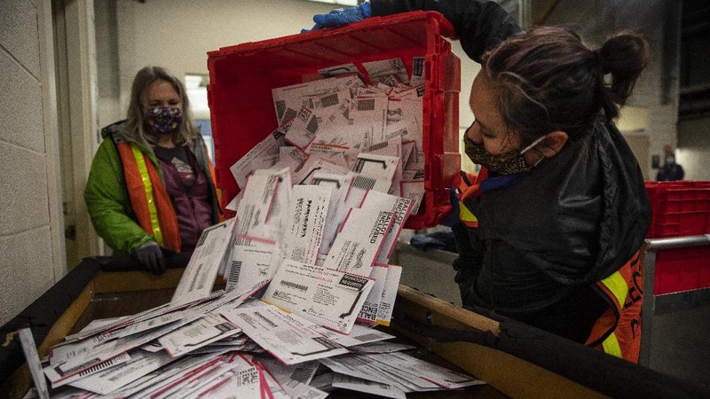 Voters at P.S. 87, on New York's Upper West Side, observe social distancing as they mark their ballots on Election Day, Tuesday, Nov. 3, 2020. (AP Photo/Richard Drew)