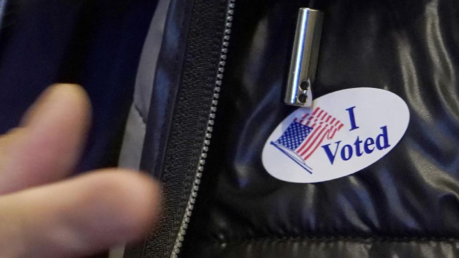 Voters at P.S. 87, on New York's Upper West Side, observe social distancing as they mark their ballots on Election Day, Tuesday, Nov. 3, 2020. (AP Photo/Richard Drew)