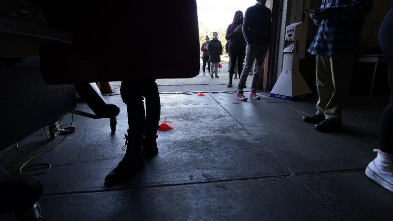 Voters at P.S. 87, on New York's Upper West Side, observe social distancing as they mark their ballots on Election Day, Tuesday, Nov. 3, 2020. (AP Photo/Richard Drew)