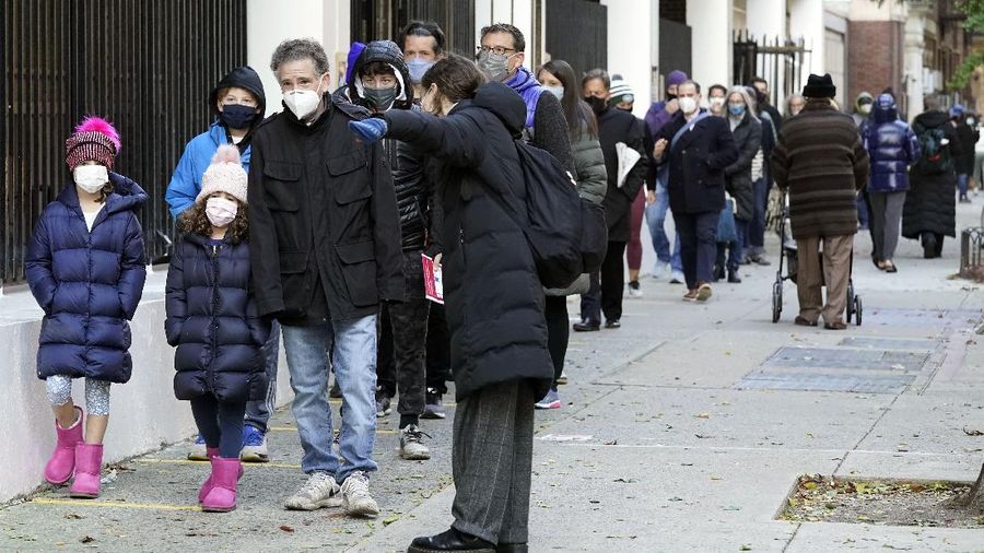 Voters at P.S. 87, on New York's Upper West Side, observe social distancing as they mark their ballots on Election Day, Tuesday, Nov. 3, 2020. (AP Photo/Richard Drew)