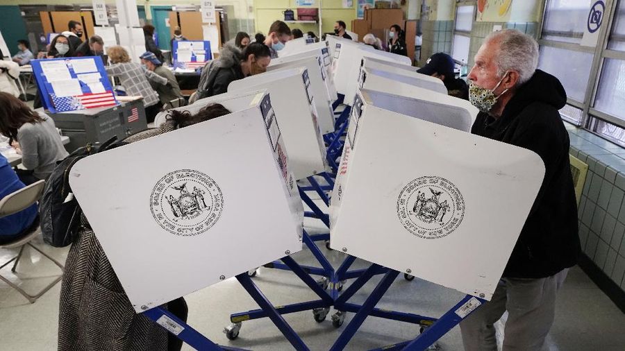 Voters at P.S. 87, on New York's Upper West Side, observe social distancing as they mark their ballots on Election Day, Tuesday, Nov. 3, 2020. (AP Photo/Richard Drew)