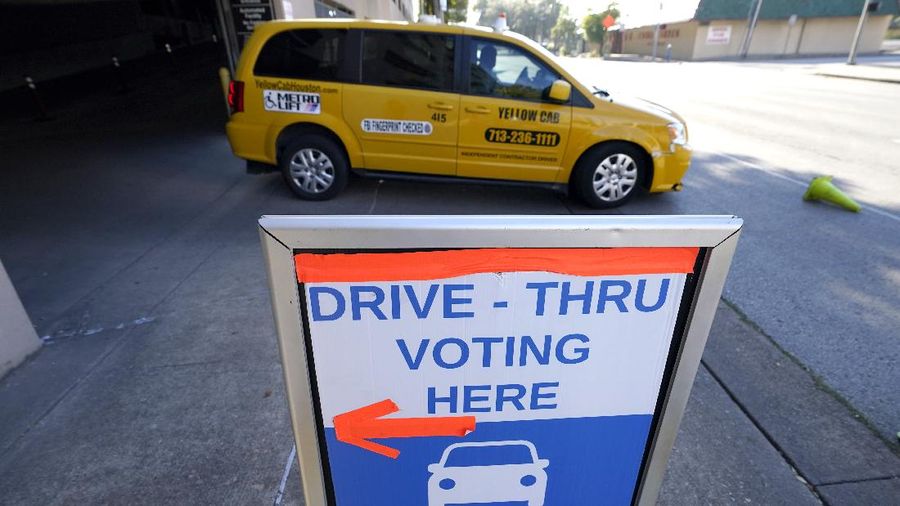 Voters at P.S. 87, on New York's Upper West Side, observe social distancing as they mark their ballots on Election Day, Tuesday, Nov. 3, 2020. (AP Photo/Richard Drew)