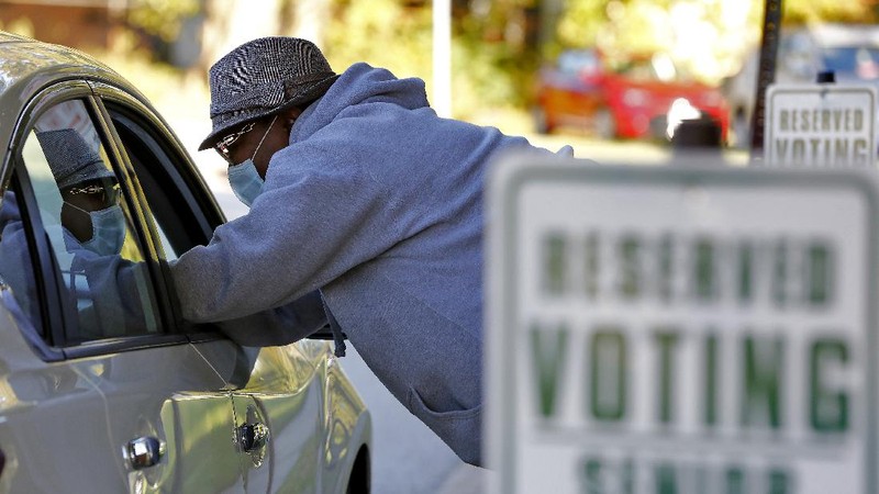 Voters at P.S. 87, on New York's Upper West Side, observe social distancing as they mark their ballots on Election Day, Tuesday, Nov. 3, 2020. (AP Photo/Richard Drew)