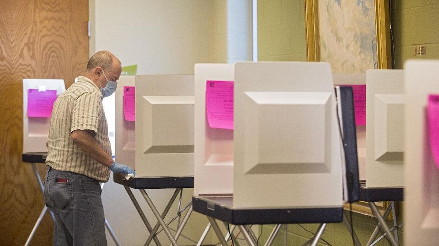 Voters at P.S. 87, on New York's Upper West Side, observe social distancing as they mark their ballots on Election Day, Tuesday, Nov. 3, 2020. (AP Photo/Richard Drew)