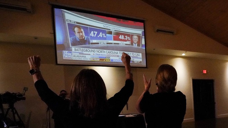 A man watches results come in on a screen set up at an election night gathering at Independence Mall , Tuesday, Nov. 3, 2020, in Philadelphia. (AP Photo/Michael Perez)