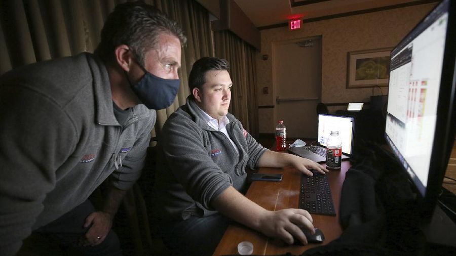 Seventh District GOP candidate Nick Freitas, R-Culpeper, left, and his campaign manager, Joe Delilets, right, check election returns in the Freitas 