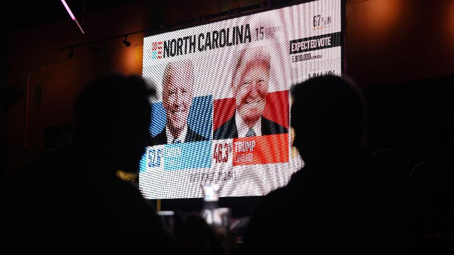 A man watches results come in on a screen set up at an election night gathering at Independence Mall , Tuesday, Nov. 3, 2020, in Philadelphia. (AP Photo/Michael Perez)