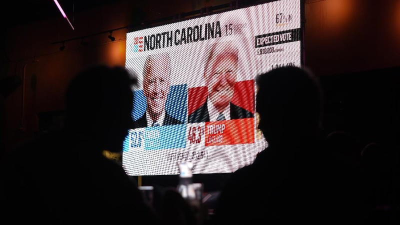 A man watches results come in on a screen set up at an election night gathering at Independence Mall , Tuesday, Nov. 3, 2020, in Philadelphia. (AP Photo/Michael Perez)